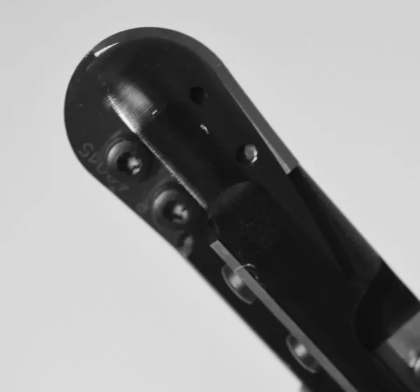 Close-up of industrial boring head featuring adjustable carbide cutting inserts, precision adjustment screws, and black coating for CNC lathe and milling operations