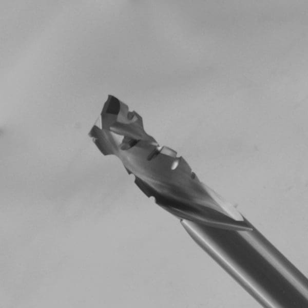 Multi-fluted twist drill bit with complex spiral cutting geometry and self-centering tip on metallic shank